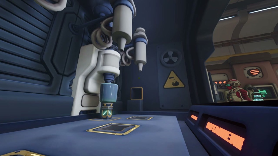 The robotic nozzle arm lowering over the cup on one of the floor pads