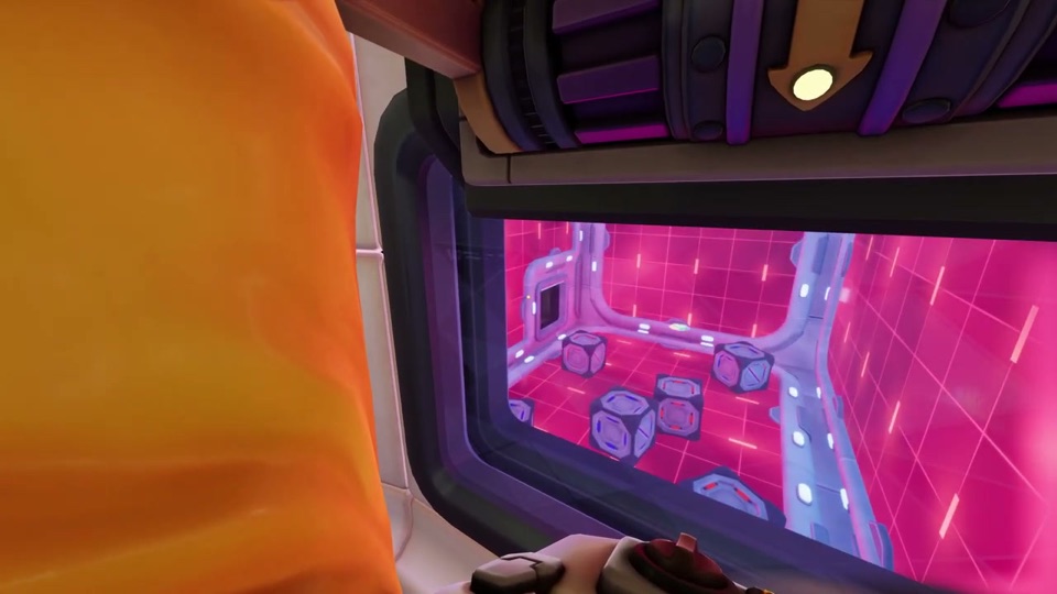 Window into the anti-gravity room with a pink grid floor and grey cubes scattered on it