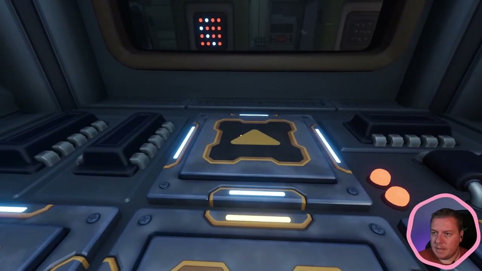 The small player's control pad with a large up-arrow button and two orange lights, with the 4x4 printer grid visible through the window above