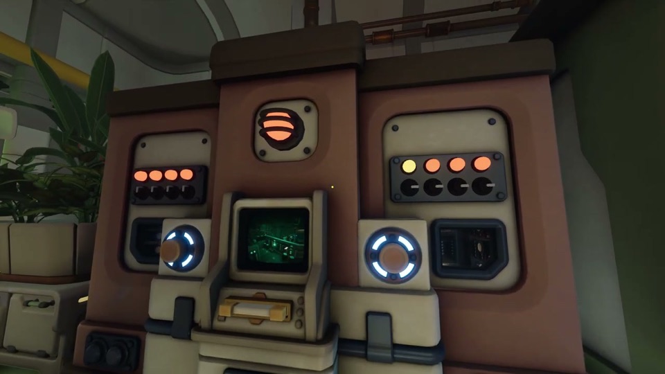 The outside console: two panels, each with four orange lights over four black dials, two big round buttons ringed with blue light, a floppy slot and a green monitor in the middle